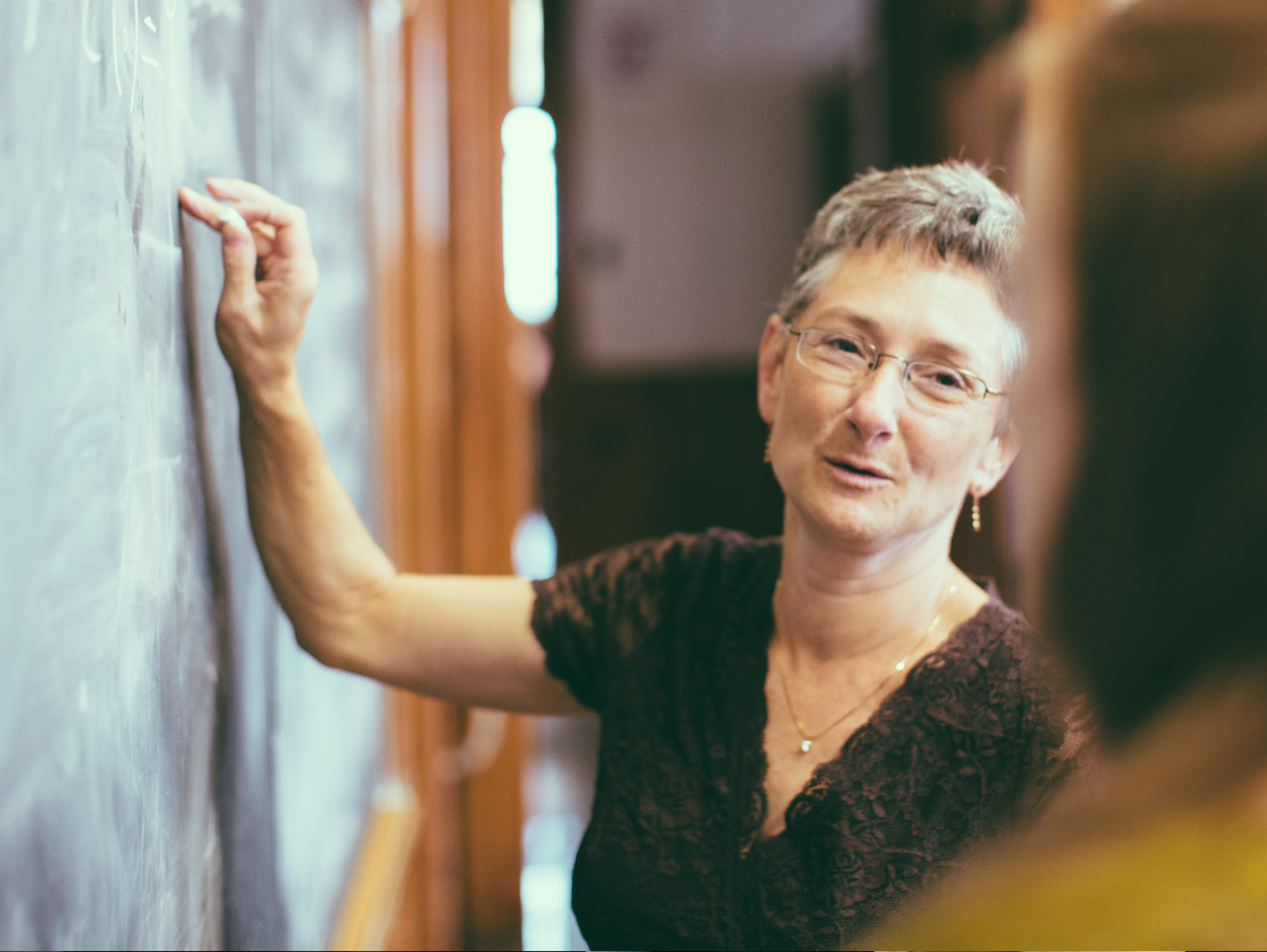 lecturer writing on a chalkboard